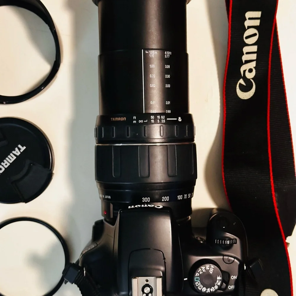 Canon DSLR with Black Tamron Zoom Lens and Red-Trim Strap